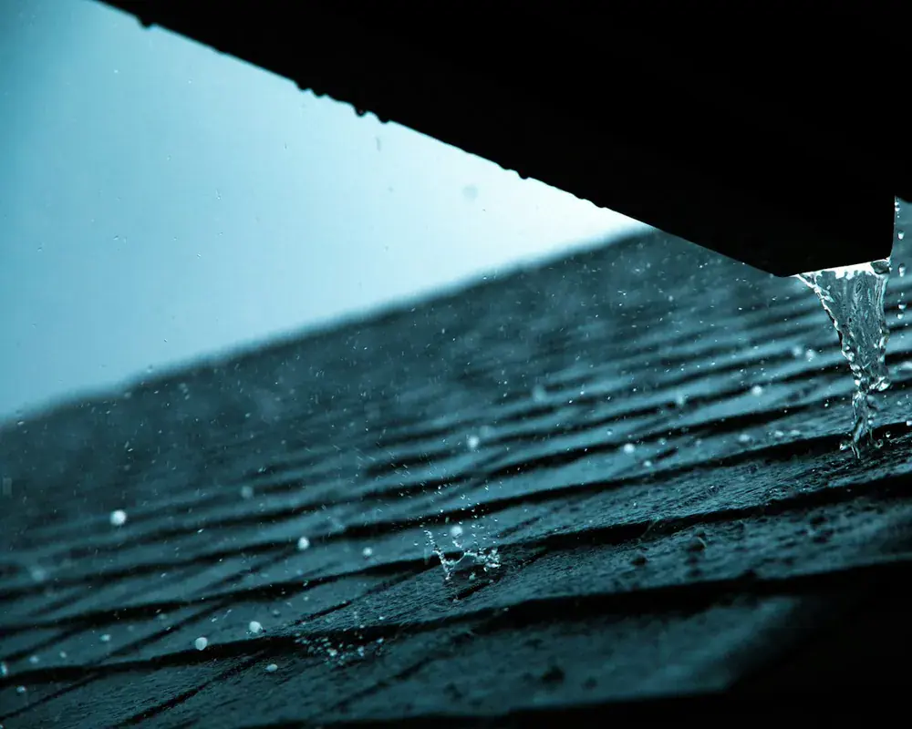 uPVC rainwater guttering fixed along a tiled roof edge on a UK home